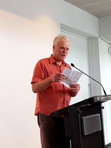 Fraser Mackay reads during the launch of Weathering the Future.